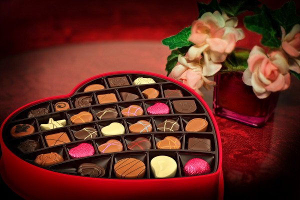 Heart shaped box of chocolates and roses.