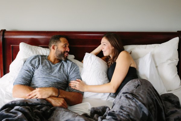 Loving couple talking in bed